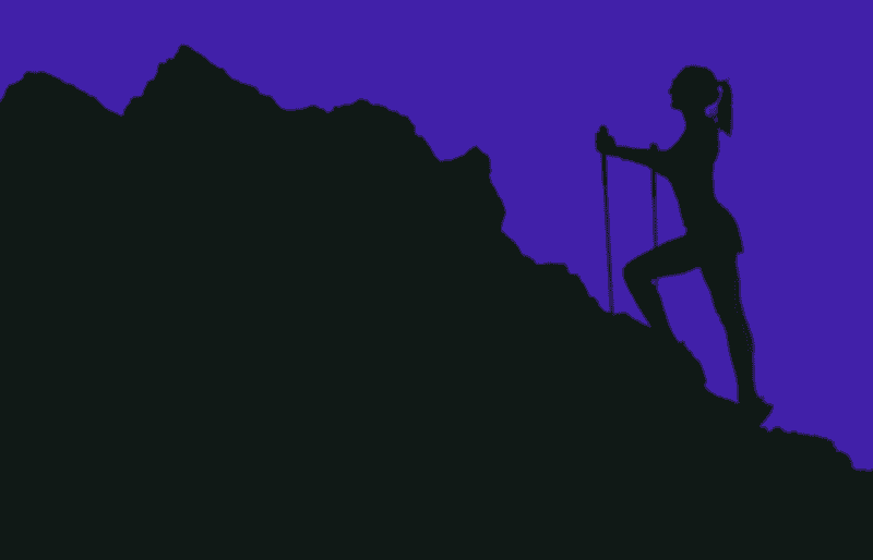 Woman climbing a mountain.
